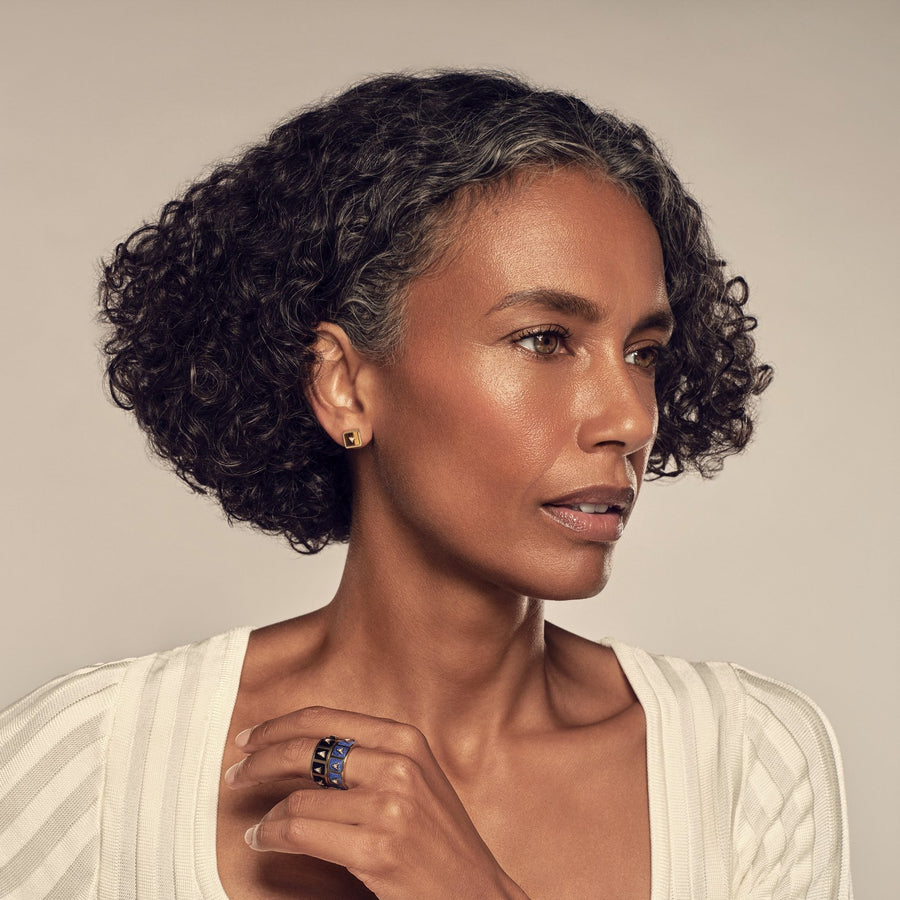 Model in profile wearing Nova Stud Earrings and stacked Nova Stacker Rings in blue lapis and black onyx, photographed by Vijat M