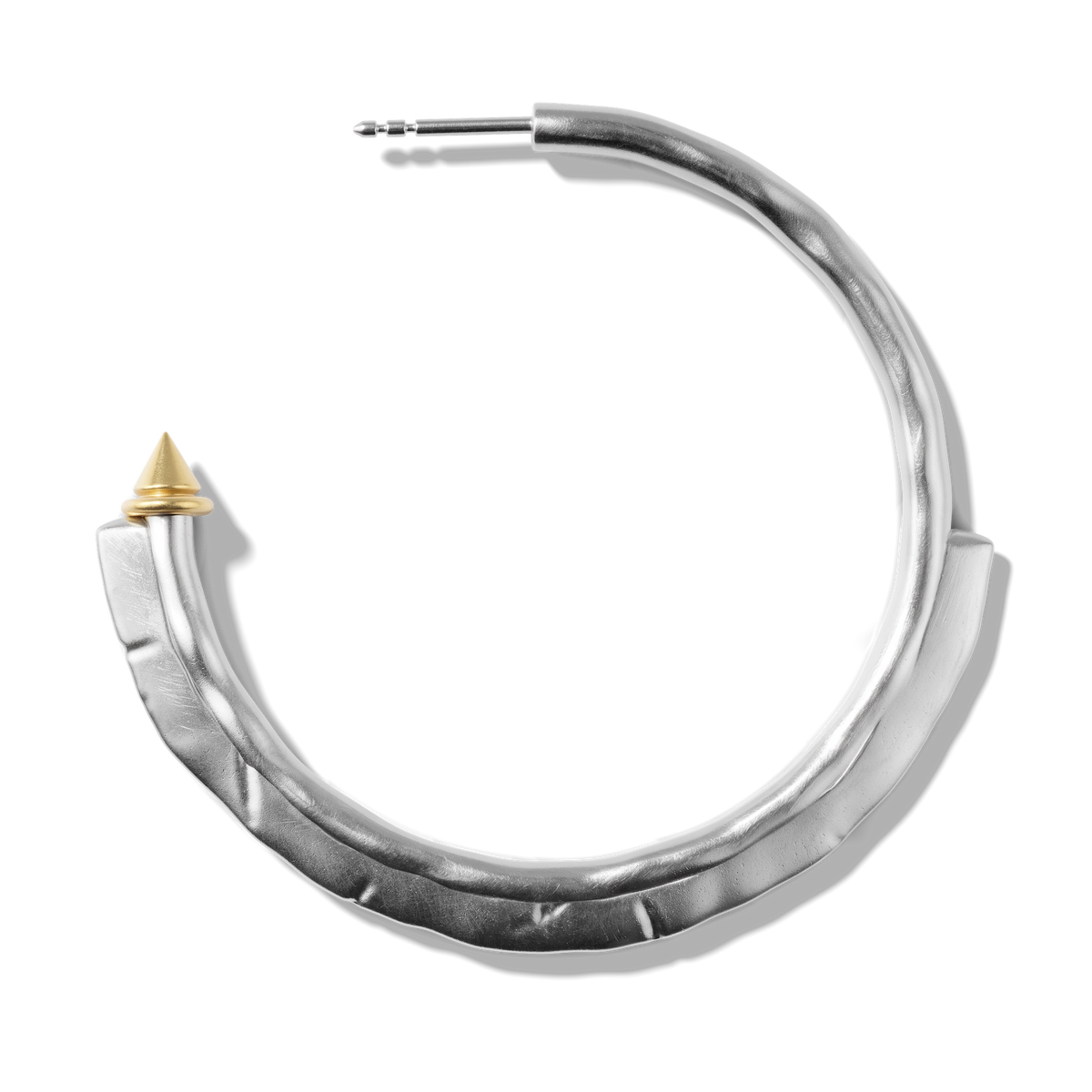 Close-up of a single Harlow Arch Hoop in sterling silver, showing the hammered arch and stud tip