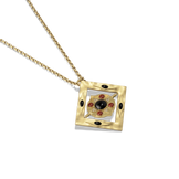 Hathor Spinning Pendant Necklace at a three-quarter angle, showing the depth of the gold frame and spinning onyx centre