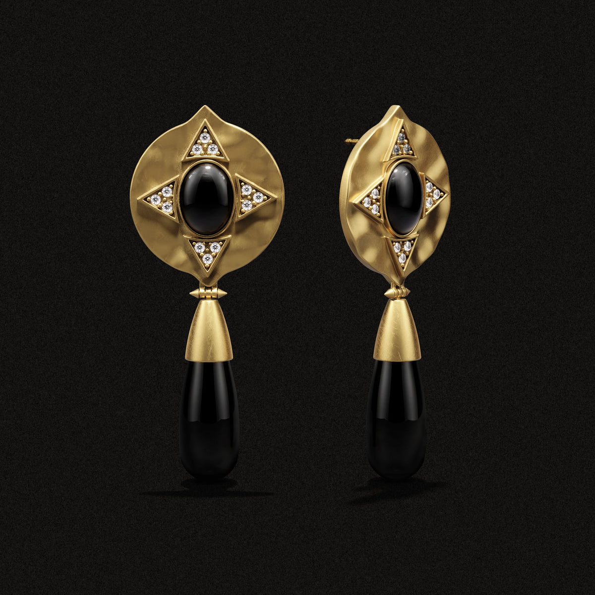 Hathor Teardrop Earrings in black onyx and 14k gold plate, three-quarter view on a black background