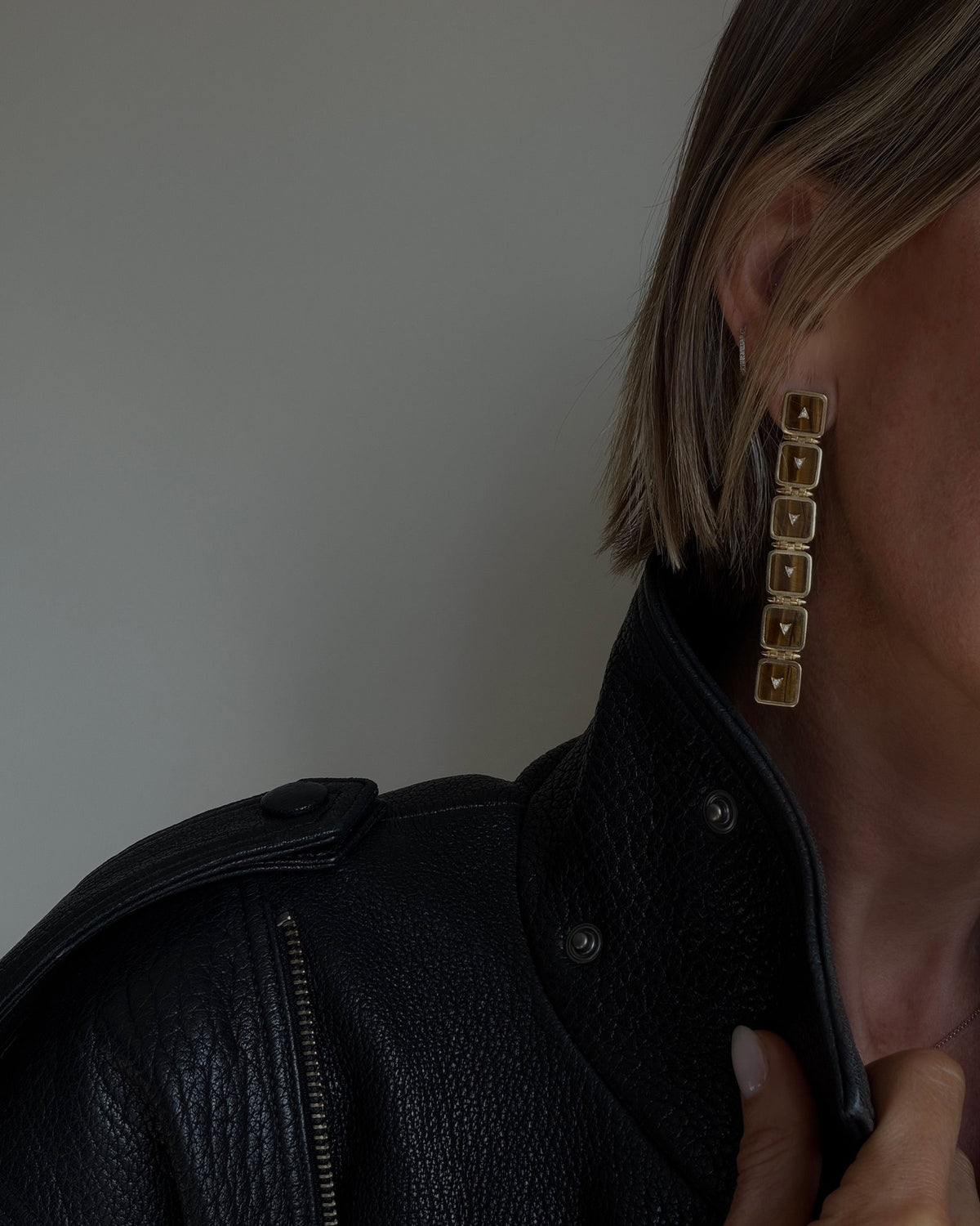 Nova Stacker Drop Earring in tiger's eye against a black leather collar