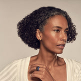 Model in profile wearing the Nova Stacker Ring in blue lapis stacked with black onyx