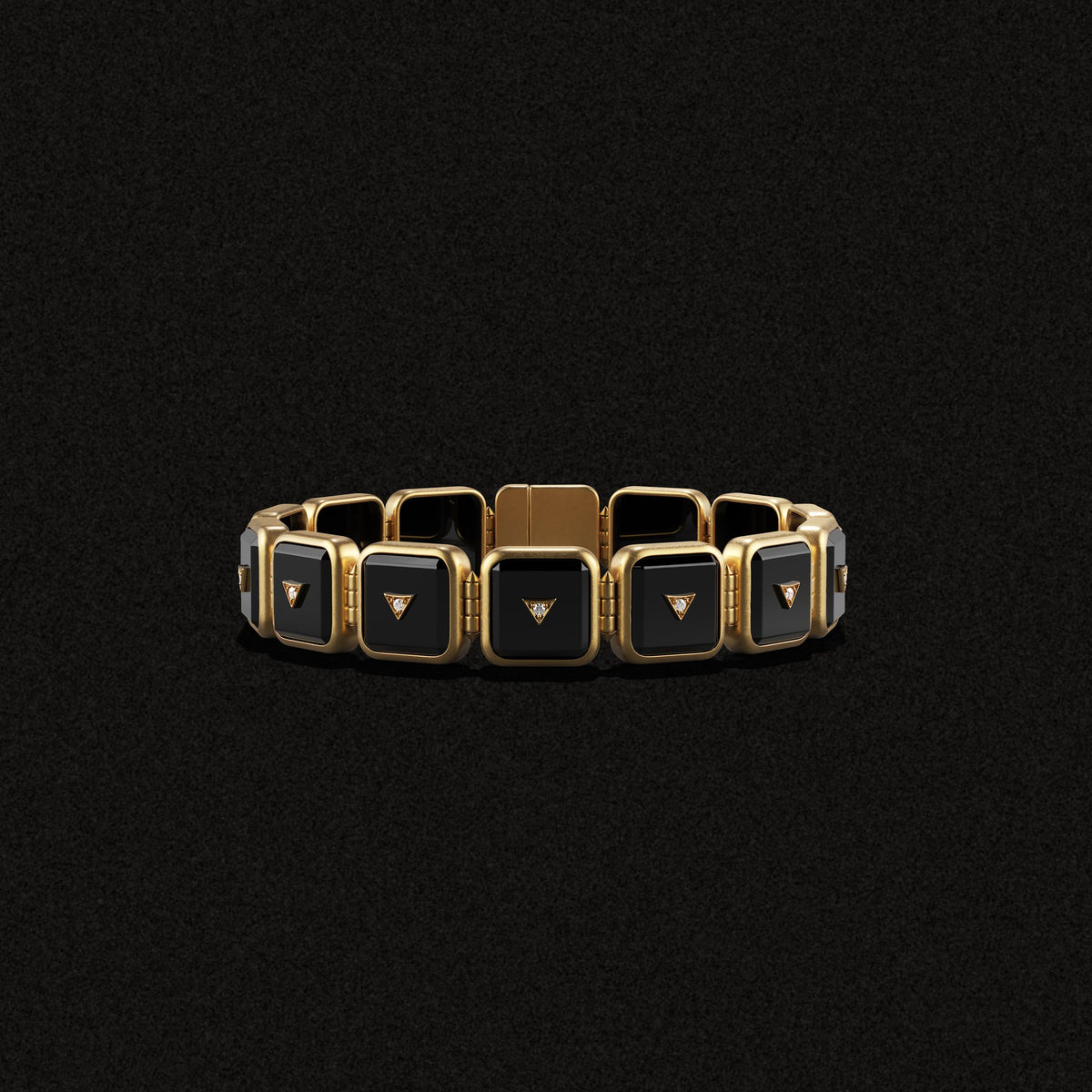 Petite Nova Stacker Bracelet in black onyx and gold, laid flat on a black background
