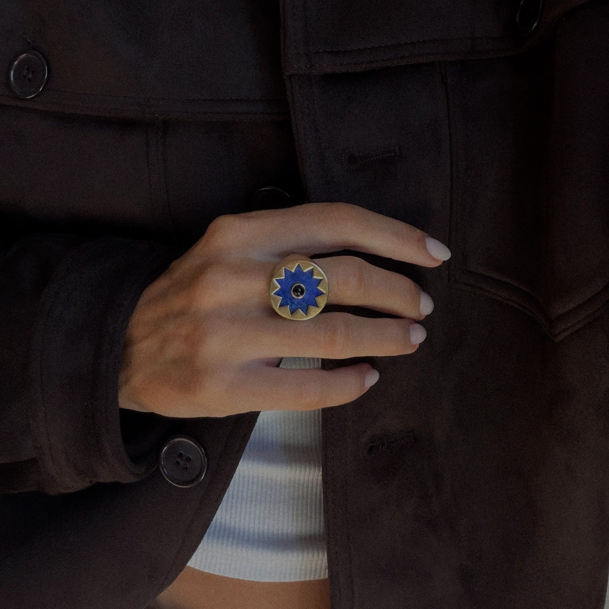 Sunburst Signet Ring in blue lapis worn with a brown suede jacket