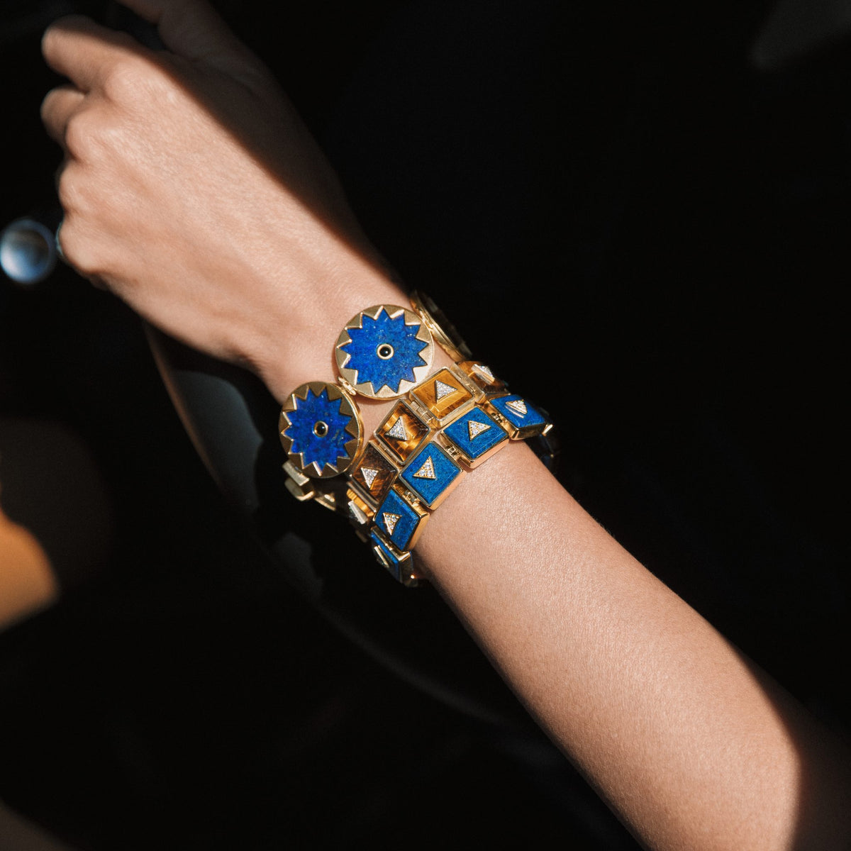 Close view of the Sunburst Statement Bracelet in blue lapis on the wrist