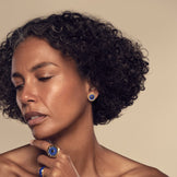 Model wearing the Sunburst Stud Earrings in blue lapis with the Sunburst Cocktail Ring